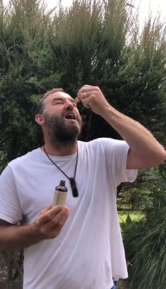 Bio Gold customer taking Pine Pollen Supercharge® drops under the tongue