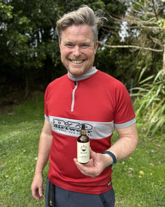 Tom holding a bottle of Pine Pollen Supercharge®