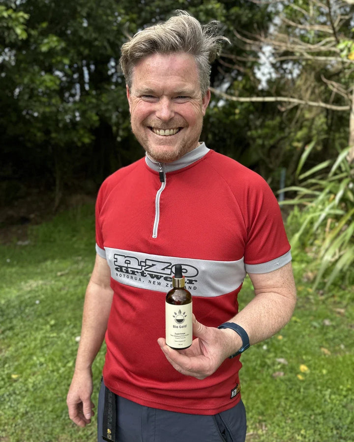 Tom holding a bottle of Pine Pollen Supercharge®